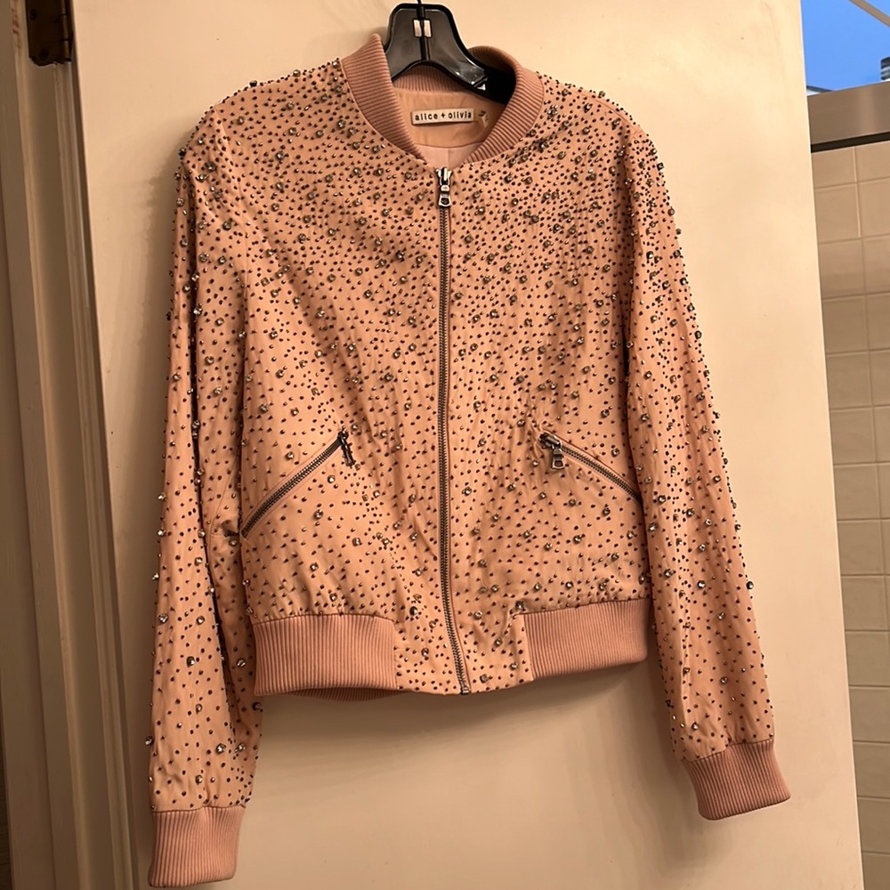This light pink jacket With rhinestones perfect condition.